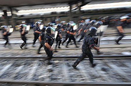 Riot policemen run after protesters who stand on a track of Termini station during a protest against the upcoming G8 summit on July 7, 2009 in Rome. Italian police made around 40 arrests Tuesday as protests against the upcoming G8 summit opening on July 8 saw demonstrators hurl bottles and set fire to tyres on the streets of Rome, officials and witnesses said.